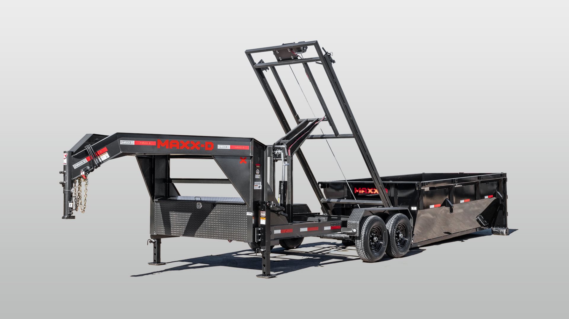 Maxx-D ROX gooseneck roll-off dump trailer with the hoist raised