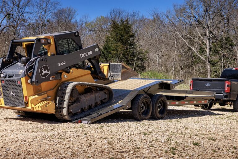 Deere 325G compact track loader driving onto a Maxx-D G8X deckover equipment trailer