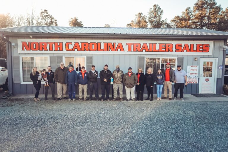 The NC Trailers team standing in front of the North Carolina Trailer Sales building in Thomasville