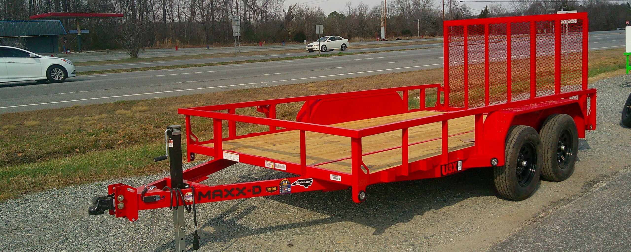Red Maxx-D U3X utility landscape trailer with mesh ramp gate on the NC Trailers lot in Thomasville, North Carolina