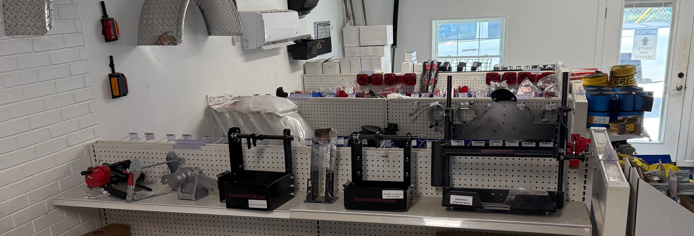 Trailer winches, couplers, lights and towing hardware on the parts counter at NC Trailers