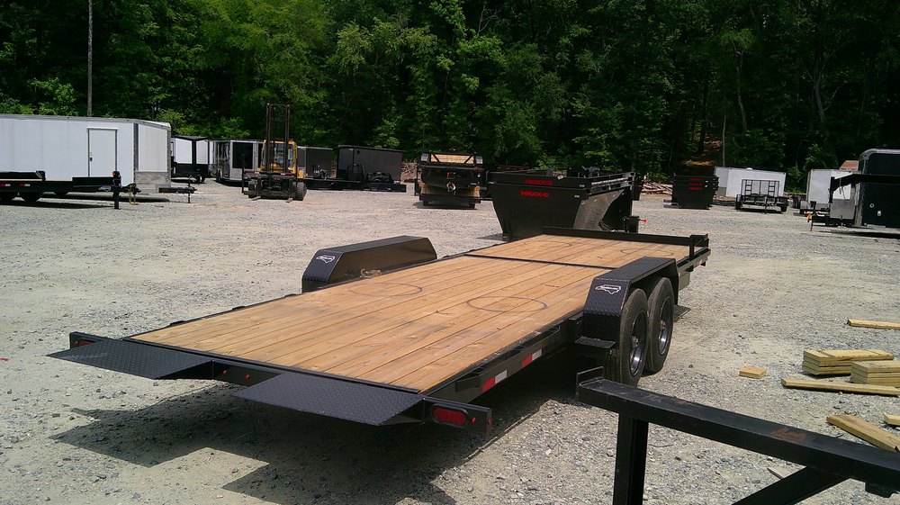 Nolan 7x22 tilt deck equipment trailer with the deck tilted to the ground for loading at NC Trailers