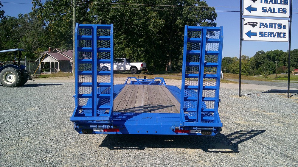 Stand-up rear ramps and wood deck on a Horizon 8.5x22 equipment trailer at NC Trailers