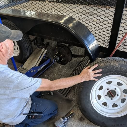 NC Trailers technician doing bearing and brake service on a trailer wheel hub in our service shop
