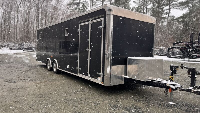 Black 8.5x26 tandem-axle enclosed car hauler with side door and front stone guard on the NC Trailers lot