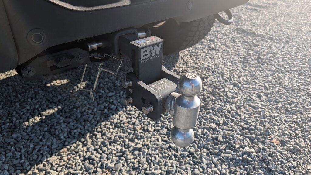 B&W dual-ball mount with a 2 inch hitch ball stamped 7,500 lbs on a pickup truck receiver