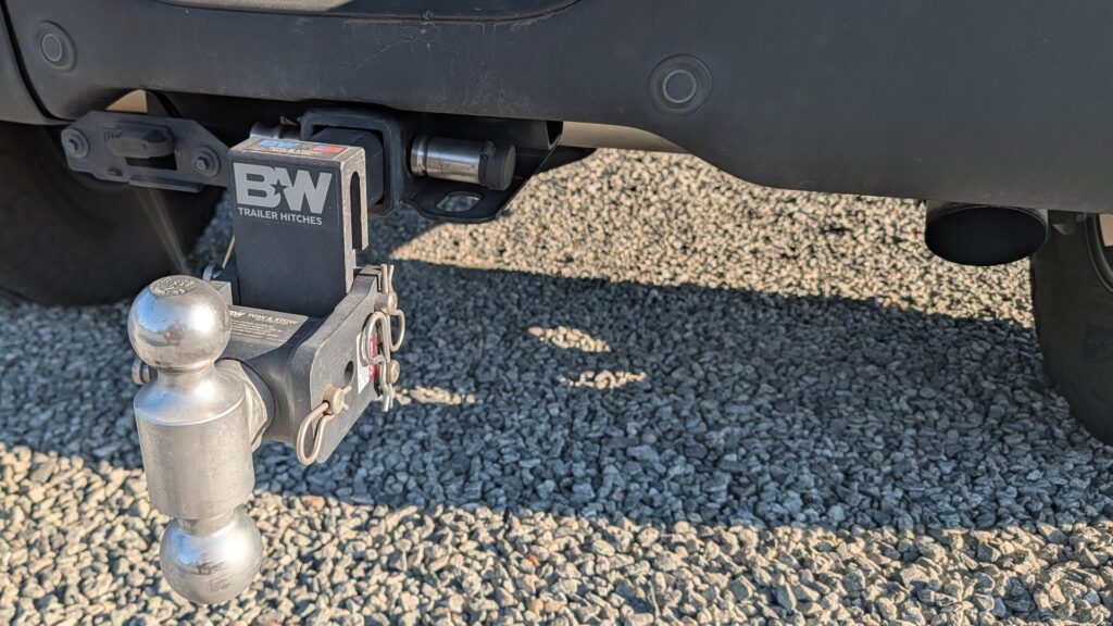 B&W Tow & Stow adjustable dual-ball mount pinned into a pickup truck receiver hitch